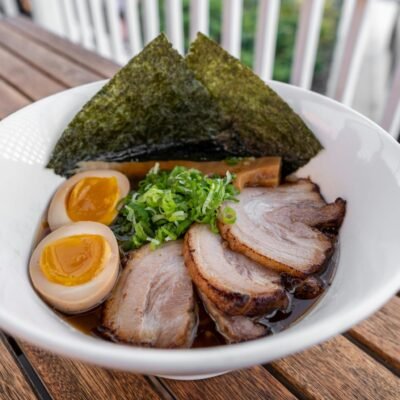 A bowl of ramen with meat and eggs