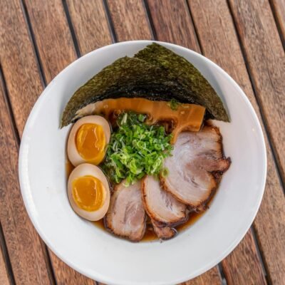 A bowl of ramen with meat and eggs